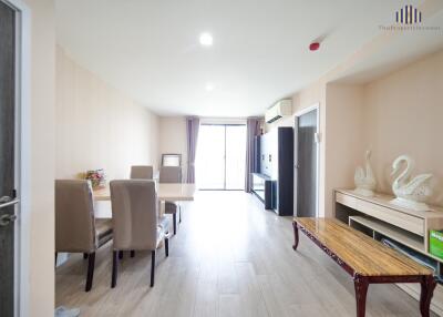 Spacious, well-lit living room with dining area