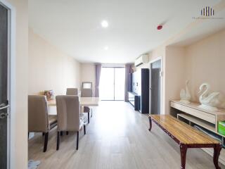 Spacious, well-lit living room with dining area