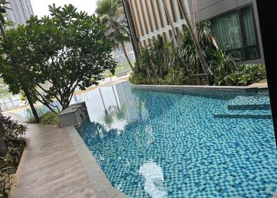 Outdoor swimming pool next to a modern building