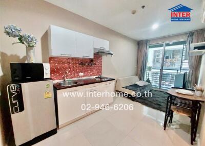 Modern kitchen area with dining space and balcony access