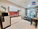 Modern kitchen area with dining space and balcony access