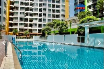 Outdoor swimming pool in front of modern apartment building