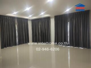 Spacious living room with glossy floors and black curtains