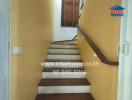 Indoor staircase with wooden steps and yellow walls