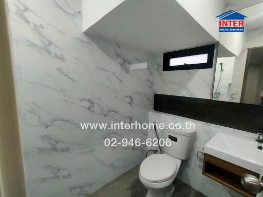 Modern bathroom with marble walls and a window