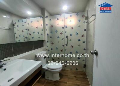 Modern bathroom with sink, toilet and shower enclosure