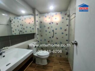 Modern bathroom with sink, toilet and shower enclosure