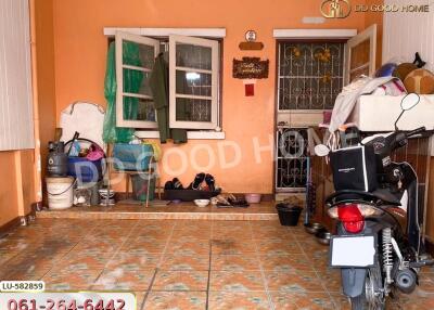 Property entrance with tiled floor and various belongings