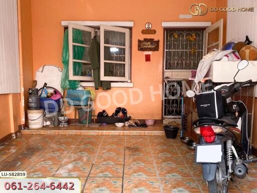 Property entrance with tiled floor and various belongings