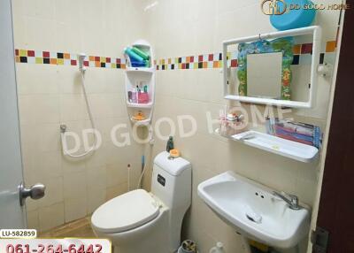 Bathroom with shower, toilet, sink, and wall shelves