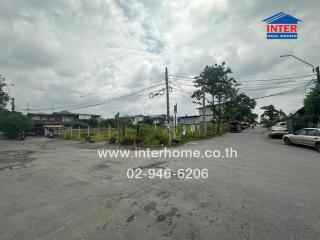 Empty plot of land for sale on a street corner