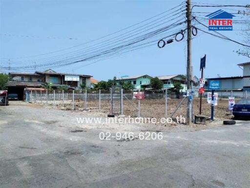 Open plot of land with surrounding residential buildings