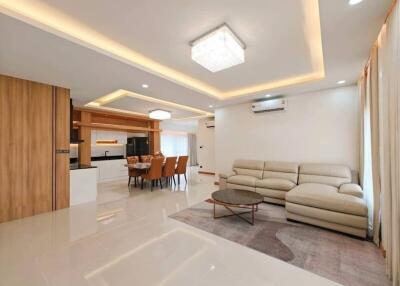 spacious living and dining area with modern lighting