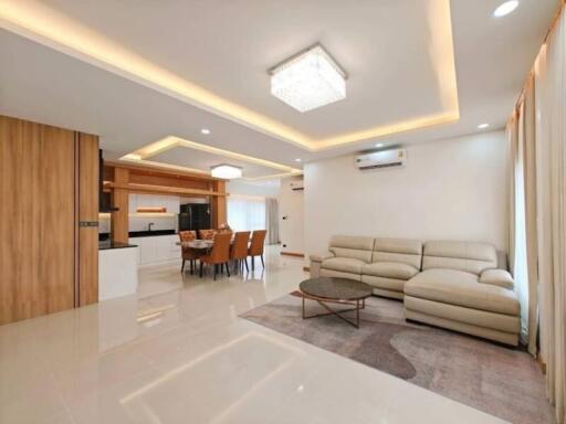 spacious living and dining area with modern lighting