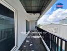 Outdoor balcony with weathered flooring and railing