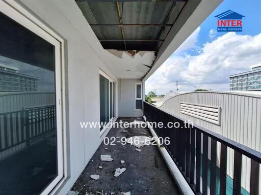 Outdoor balcony with weathered flooring and railing