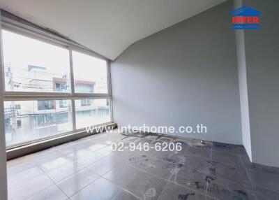 Empty room with large windows and tiled floor