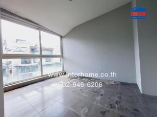 Empty room with large windows and tiled floor