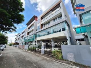 Modern multi-story residential building with glass balconies