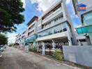 Modern multi-story residential building with glass balconies