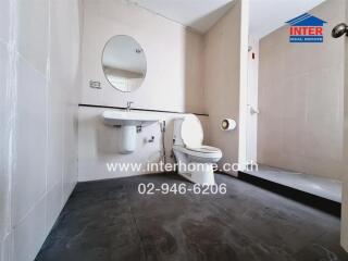 Modern bathroom with toilet, sink, and mirror