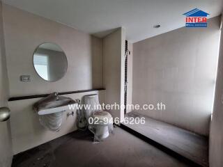 Modern bathroom with a round mirror, sink, and walk-in shower