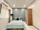 Modern bedroom with bed, wardrobe, and air conditioning