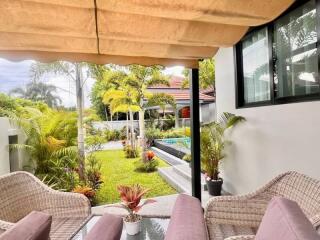 Covered outdoor seating area with garden view