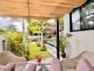 Covered outdoor seating area with garden view