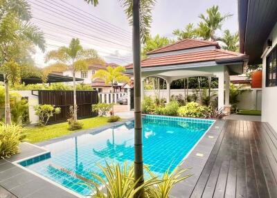 Outdoor area with swimming pool and palm trees