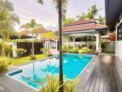 Outdoor area with swimming pool and palm trees