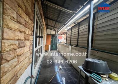 Covered outdoor area with storage and stone wall