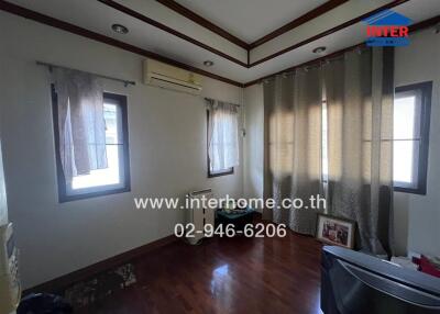 Bedroom with wooden floor and windows