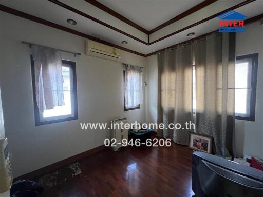 Bedroom with wooden floor and windows