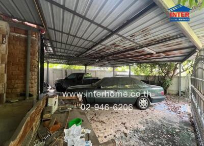 Covered garage area with two parked cars