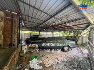 Covered garage area with two parked cars