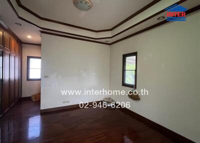 Spacious and bright bedroom with wooden floors and built-in wardrobe