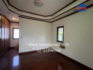 Spacious and bright bedroom with wooden floors and built-in wardrobe