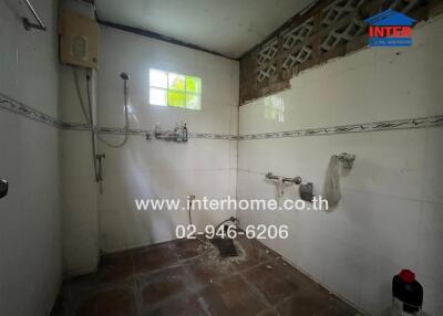 Bathroom with white tiles and ventilation featuring a shower area