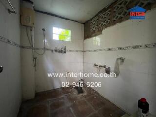 Bathroom with white tiles and ventilation featuring a shower area