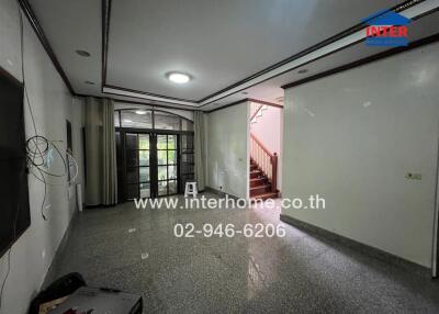 Living room with large window and stairs