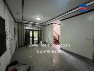 Living room with large window and stairs