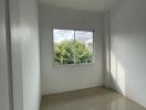 Empty bedroom with large window