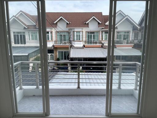 View of a balcony overlooking neighboring houses