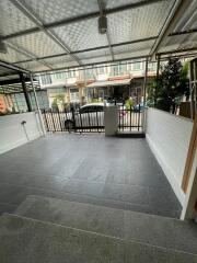 Covered garage area with tiled floor