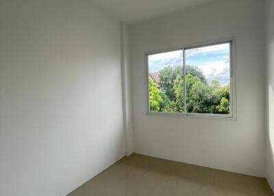 bright empty bedroom with large window