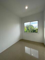 bright empty bedroom with large window