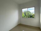 bright empty bedroom with large window