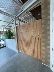 Modern covered patio with brick wall and wood fencing