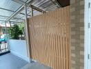 Modern covered patio with brick wall and wood fencing